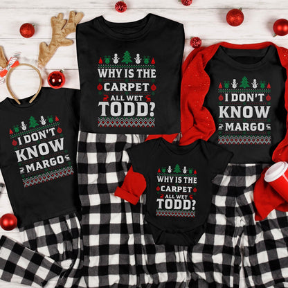 May include: Black family matching Christmas pajamas with the phrases "I DON'T KNOW MARGO" and "WHY IS THE CARPET ALL WET TODD?" printed on the shirts. The pajamas have a festive sweater design with Christmas trees and ornaments.