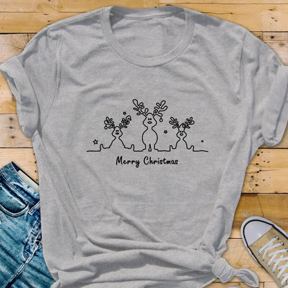 May include: A heather gray t-shirt featuring a black line drawing of three reindeer with antlers and stars. The words "Merry Christmas" are printed below the reindeer design. The shirt is made of a soft material.