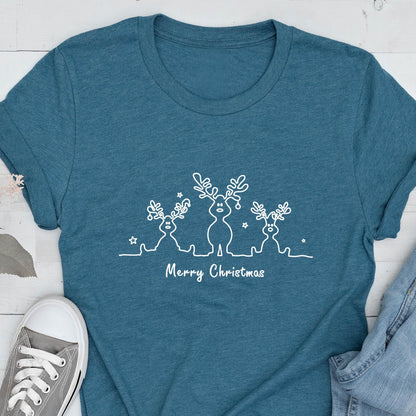 May include: Teal t-shirt featuring a white line drawing of three reindeer with star accents. The text "Merry Christmas" is below the reindeer design. A casual, festive tee.