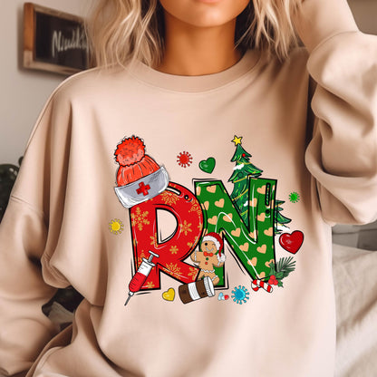 May include: A beige crewneck sweatshirt featuring a graphic print of the letters RN in red and green. The design includes a nurse cap, a syringe, a gingerbread person, a Christmas tree, hearts, snowflakes, and various medical-themed icons.