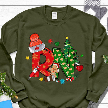 May include: An olive green crewneck sweatshirt featuring a graphic with the letters RN. The R is red with snowflakes, and the N is green with hearts. The design includes a nurse cap, a syringe, a gingerbread person, and a Christmas tree.
