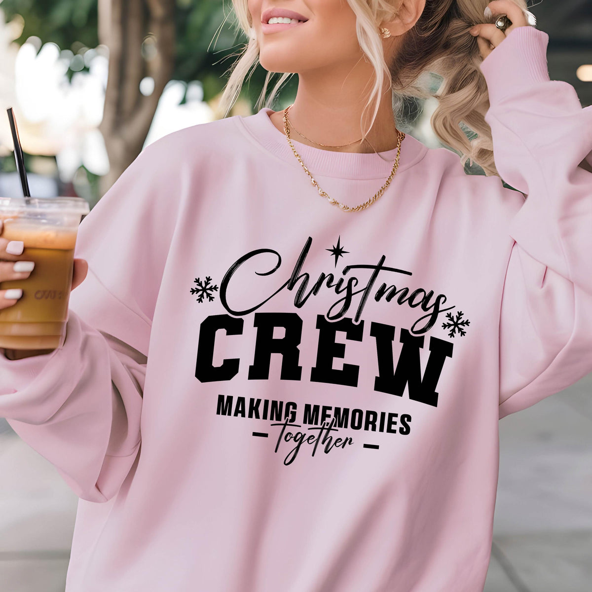 May include: A light pink long-sleeve crewneck sweatshirt featuring black text that reads Christmas CREW MAKING MEMORIES Together, accented with small black snowflake and star icons printed on the front center of the garment.
