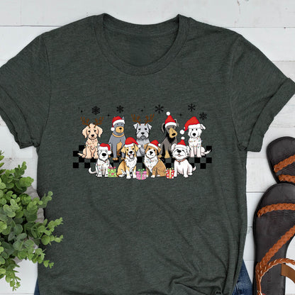 May include: Dark gray t-shirt featuring a festive graphic of various dog breeds wearing Santa hats and reindeer antlers. The dogs are arranged in a row, with snowflakes and a checkered pattern. A fun, holiday-themed design.