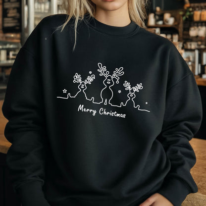 May include: A black long-sleeve sweatshirt featuring a white line art graphic of three reindeer with antlers and small stars. Below the reindeer, the text Merry Christmas is printed in a white script font across the center of the chest.