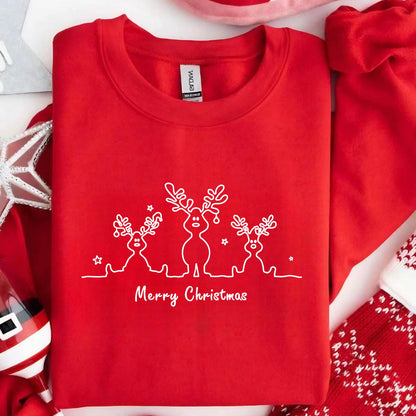 May include: A bright red crewneck sweatshirt featuring a white line art graphic of three reindeer standing in a row, accented with small stars. Below the reindeer, the text Merry Christmas is printed in a simple, clean white script font.