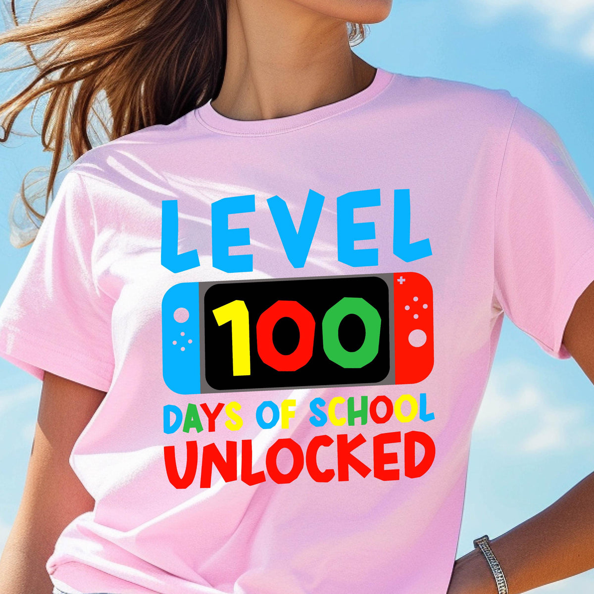 May include: Pink t-shirt with a graphic of a video game controller and the text "Level 100 Days of School Unlocked".