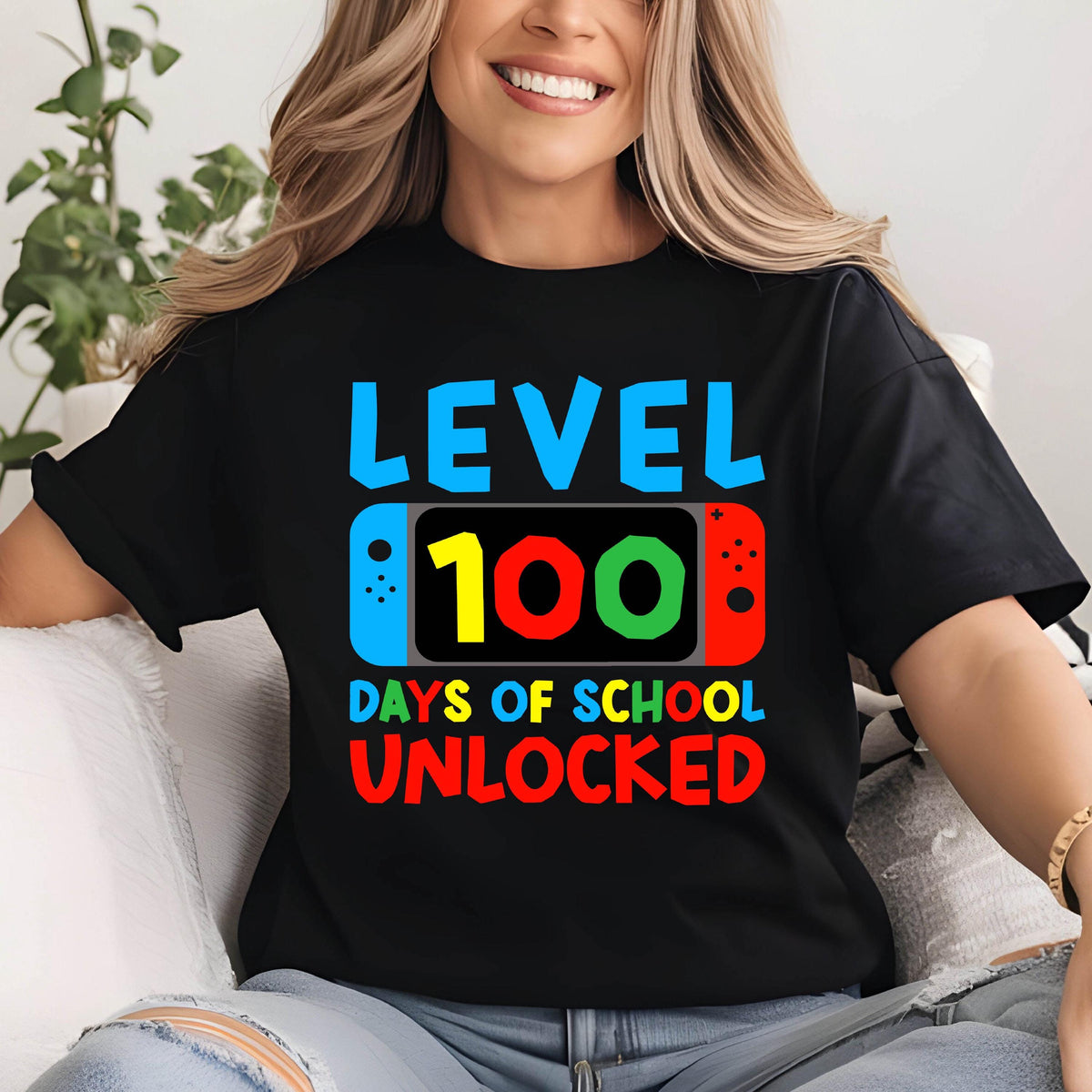 May include: Black t-shirt with a graphic of a video game controller with the text "Level 100 Days of School Unlocked".
