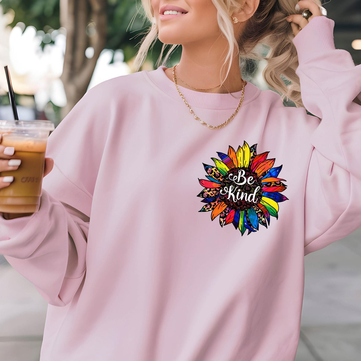 May include: Pink sweatshirt with a rainbow sunflower graphic and the text "Be Kind" in the center.