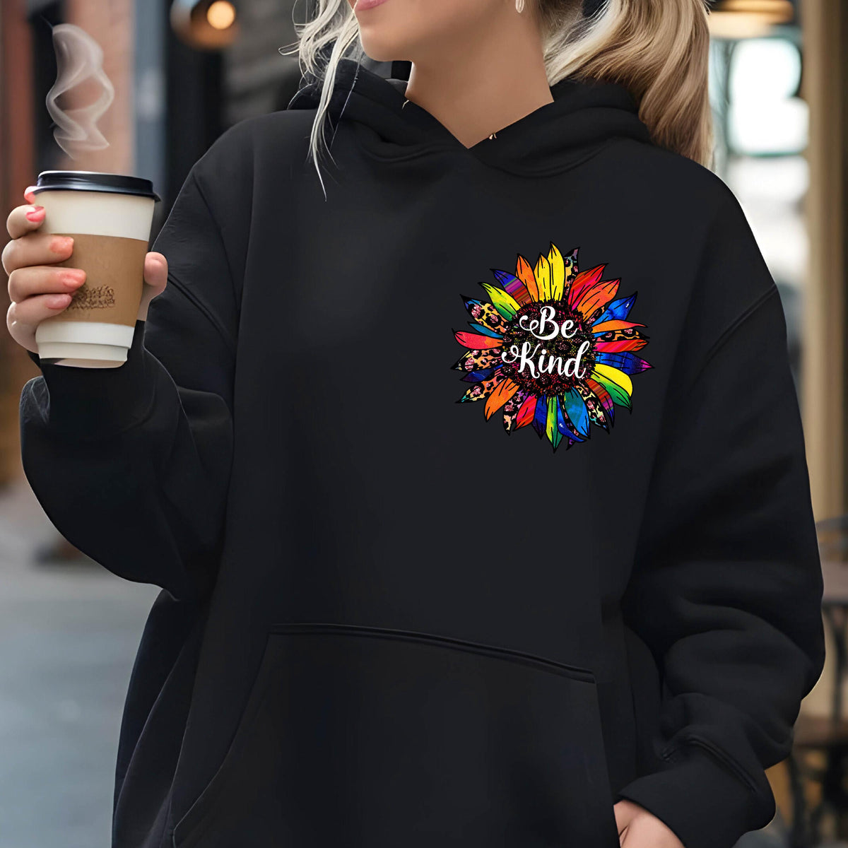 May include: Black hooded sweatshirt with a colorful sunflower graphic and the text "Be Kind" on the front.