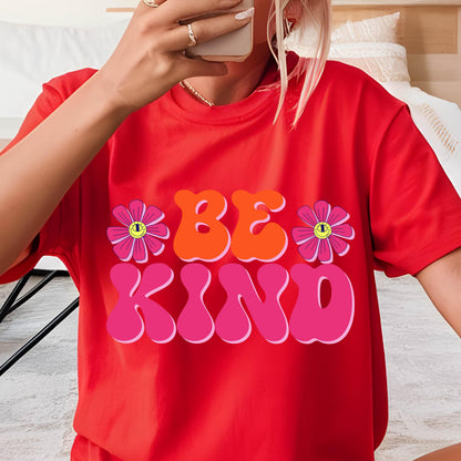 May include: Red t-shirt with a graphic print of the words "BE KIND" in pink, orange, and yellow with two pink flowers with yellow centers.
