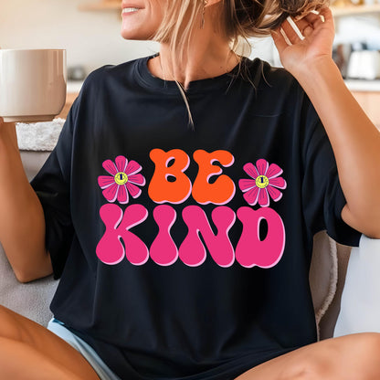 May include: Black t-shirt with a pink and orange graphic that says "Be Kind" with two pink flowers with yellow smiley faces.