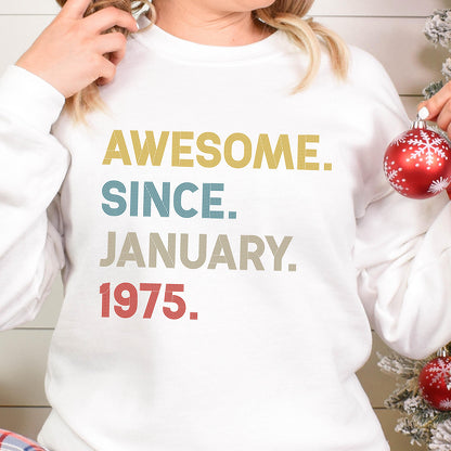 May include: White sweatshirt with the text "AWESOME. SINCE. JANUARY. 1975." in yellow, teal, tan, and red. The sweatshirt is a crew neck style.