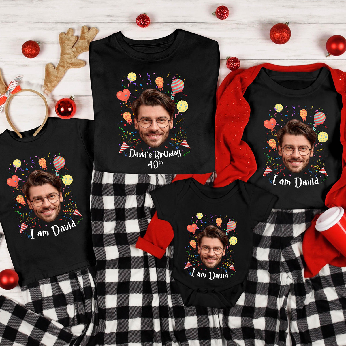 May include: A collection of black t-shirts and a baby bodysuit featuring a custom graphic of a man with glasses, colorful balloons, and confetti. The shirts display the text 'I am David' or 'David's Birthday 40th' in white script lettering.