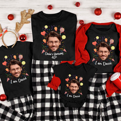 May include: A collection of black t-shirts and a baby bodysuit featuring a custom graphic of a man with glasses, colorful balloons, and confetti. The shirts display the text 'I am David' or 'David's Birthday 40th' in white script lettering.