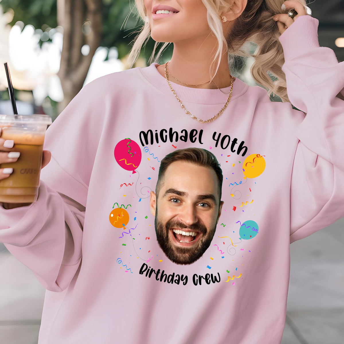 May include: Pink sweatshirt with a birthday design featuring a man's face, balloons, confetti, and the text "Michael 40th Birthday Crew".