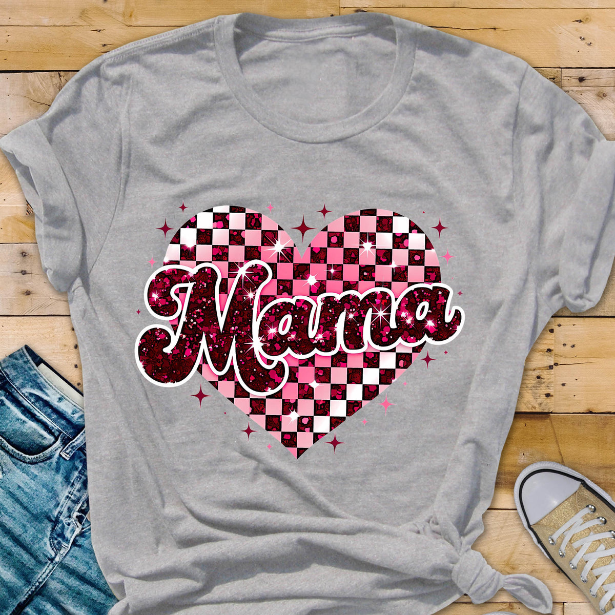 May include: Gray t-shirt with a pink and white checkered heart design and the word "Mama" in pink glitter letters.