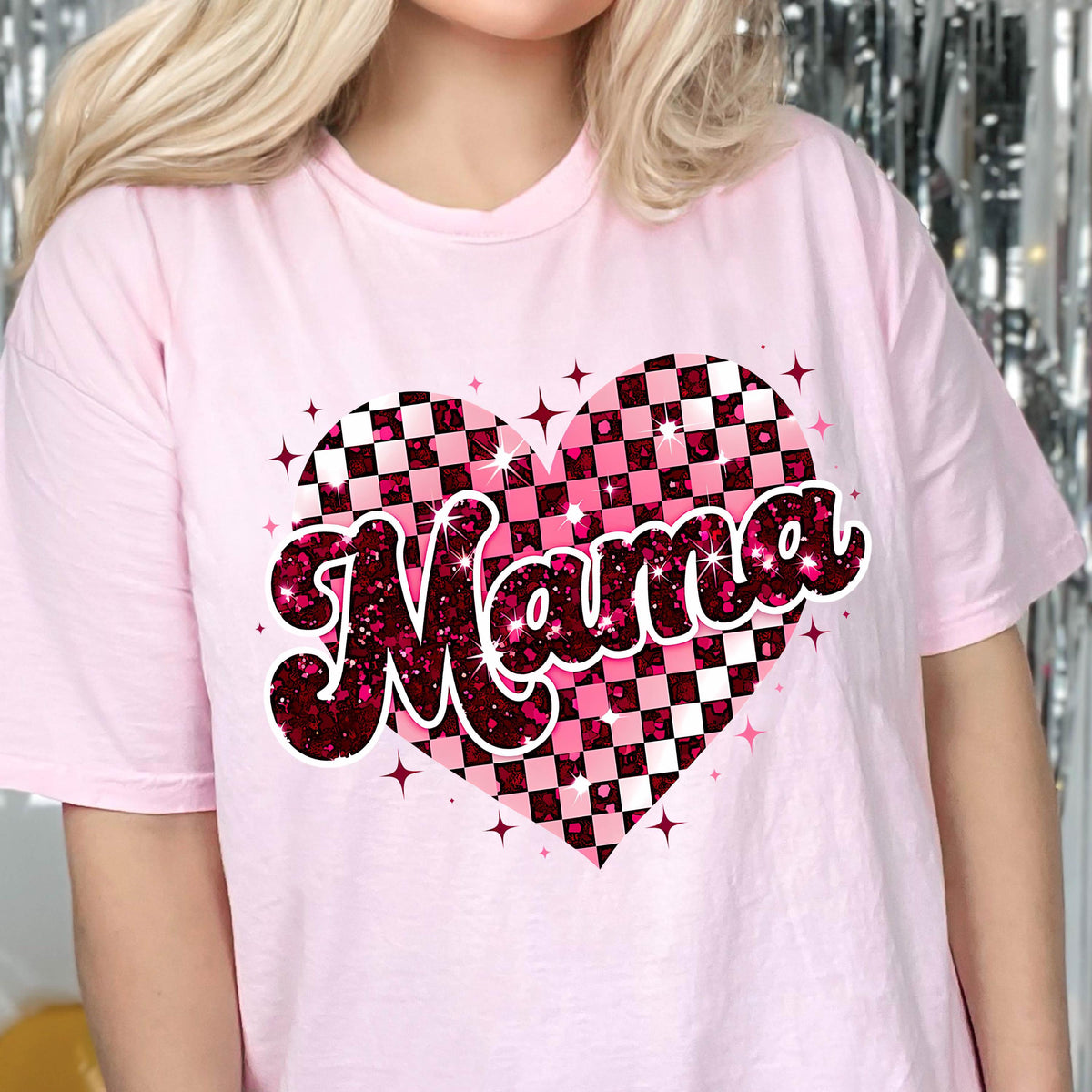 May include: Pink t-shirt with a pink and white checkered heart design and the word "Mama" in a glittery font.