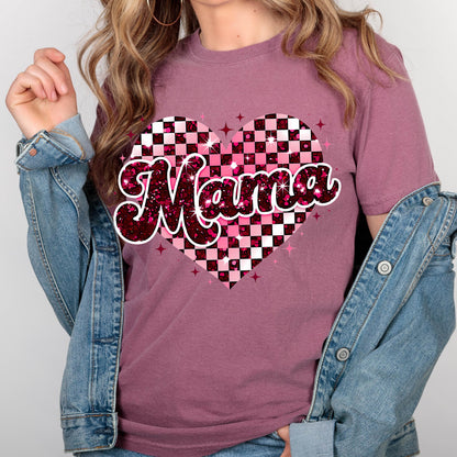 May include: Pink t-shirt with a checkered heart design and the word "Mama" in a glittery font.