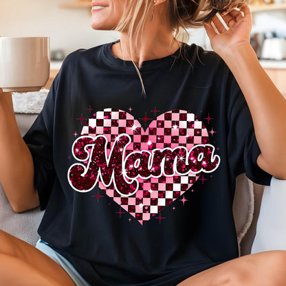 May include: Black t-shirt with a pink and white checkered heart design and the word "Mama" in pink glitter letters.