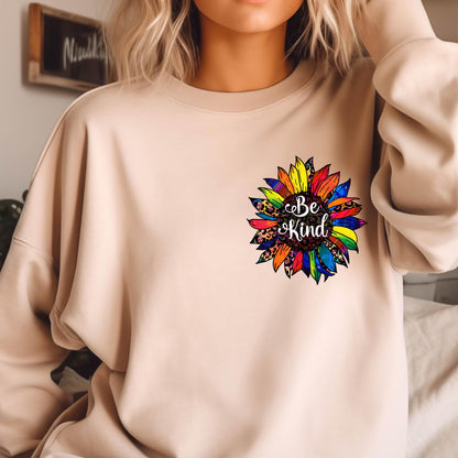 May include: A beige sweatshirt with a colorful sunflower graphic and the text "Be Kind" in the center.