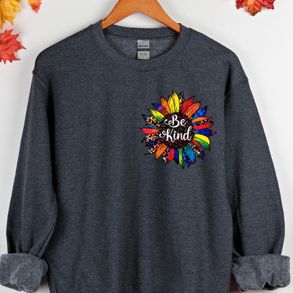 May include: A dark gray sweatshirt with a colorful sunflower design and the text "Be Kind" in the center.