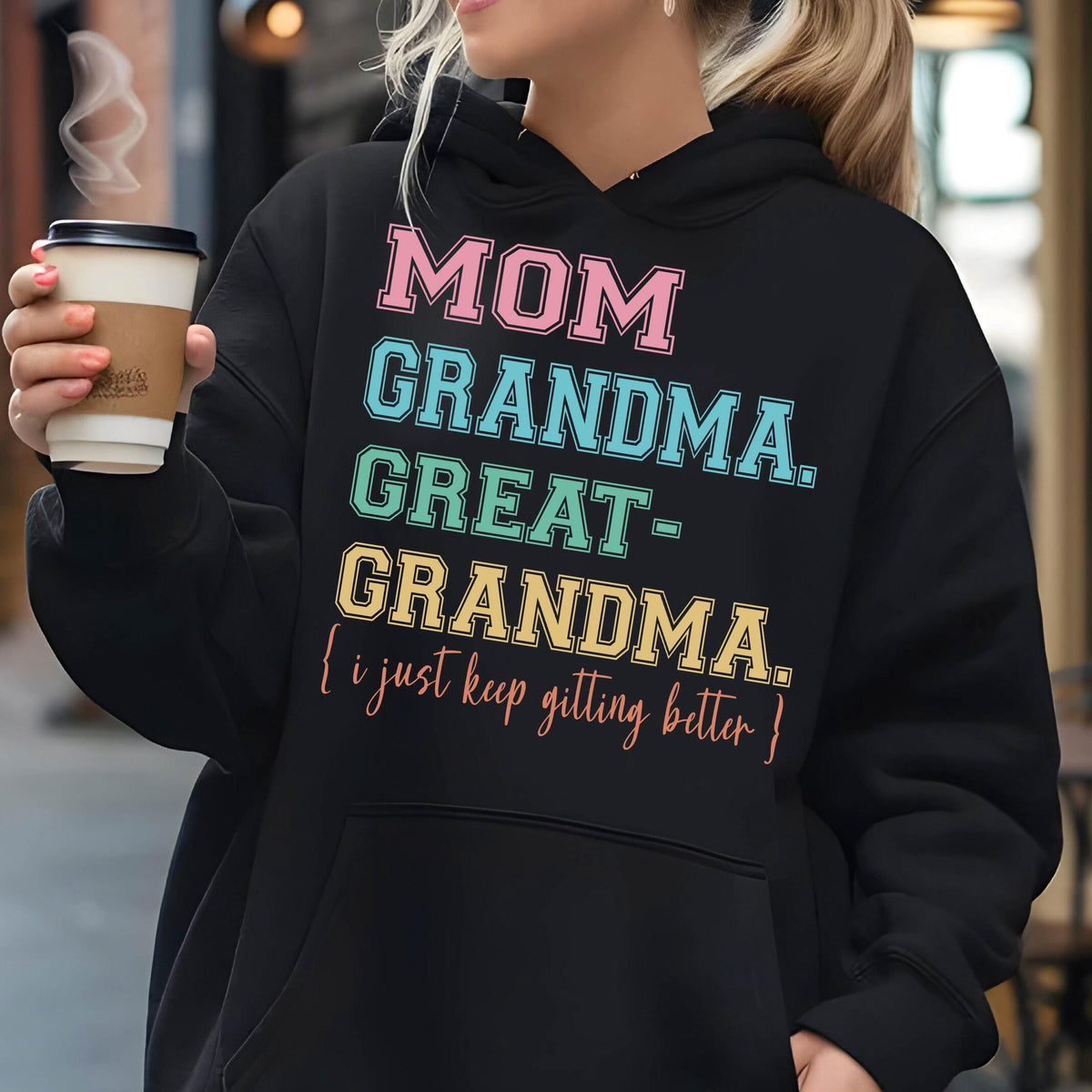 May include: Black hoodie with a colorful graphic that reads "MOM GRANDMA. GREAT-GRANDMA. {I just keep getting better}"