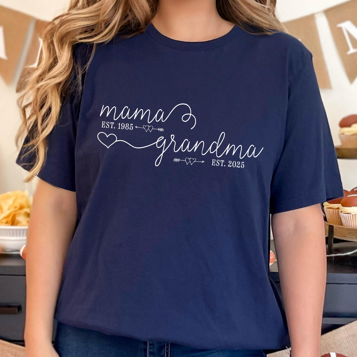May include: A navy blue t-shirt with white text that reads "mama est. 1985" and "grandma est. 2025".