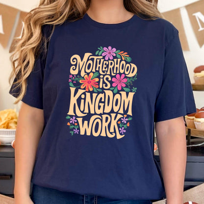 May include: A navy blue t-shirt with a floral design and the text "Motherhood is Kingdom Work" in a yellow font.