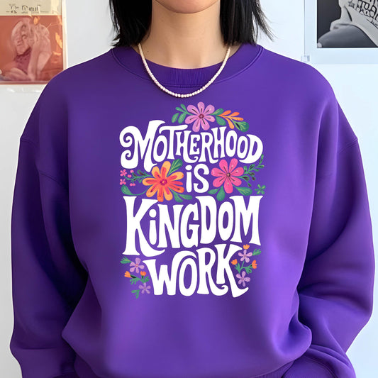 May include: Purple sweatshirt with a white graphic that says "Motherhood is Kingdom Work" surrounded by colorful flowers.