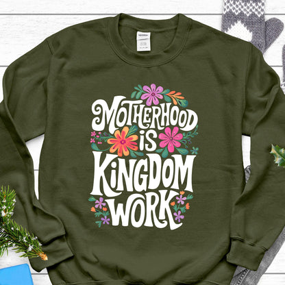 May include: Olive green sweatshirt with a white graphic that says "Motherhood is Kingdom Work" with colorful floral accents.