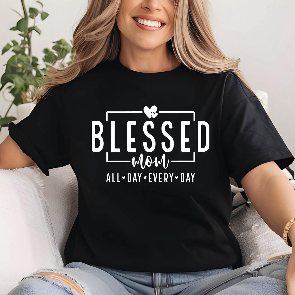 May include: Black t-shirt with white text that reads "Blessed mom all-day every-day" with a heart graphic above the word "mom".