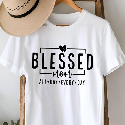 May include: White t-shirt with black text that reads "Blessed Mom All Day Every Day" with a heart symbol between each word.