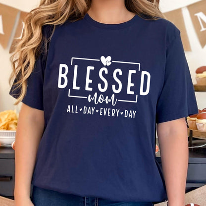 May include: Navy blue t-shirt with white text that reads "Blessed Mom All Day Every Day" with a heart graphic.