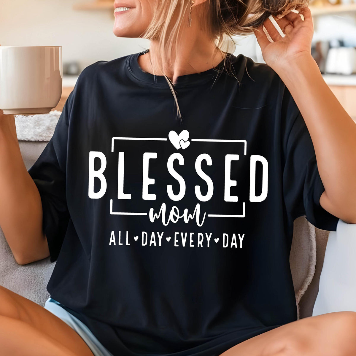 May include: Black t-shirt with white text that reads "Blessed Mom All Day Every Day" with a heart graphic.