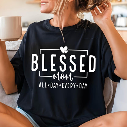 May include: Black t-shirt with white text that reads "Blessed Mom All Day Every Day" with a heart graphic.
