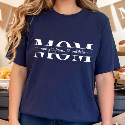 May include: A navy blue t-shirt with the word "MOM" in white letters. The names "mary", "james", and "patricia" are written below the word "MOM" with a heart symbol between each name.