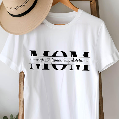 May include: White t-shirt with the word "MOM" in black letters. Underneath the word "MOM" is a black line with the names "mary", "james", and "patricia" written in cursive with a heart symbol between each name.