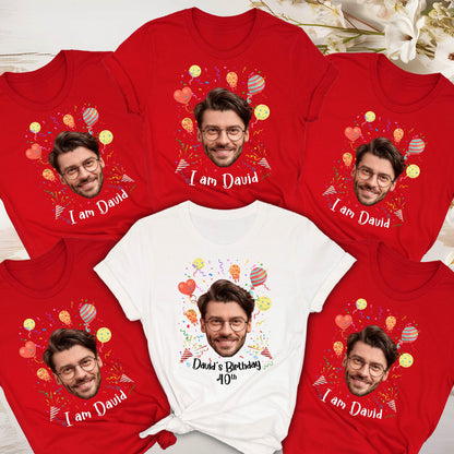 May include: Five short-sleeved t-shirts featuring a custom photo print of a man wearing glasses. Four shirts are red with the text "I am David" and one white shirt features the text "David's Birthday 40th" surrounded by colorful balloons and confetti.