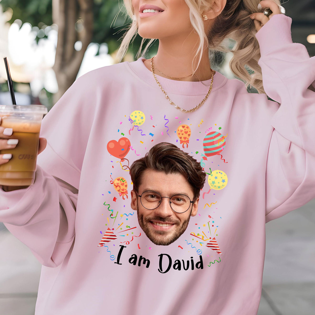 May include: Pink sweatshirt with a cartoon face and the text "I am David" surrounded by confetti and balloons.