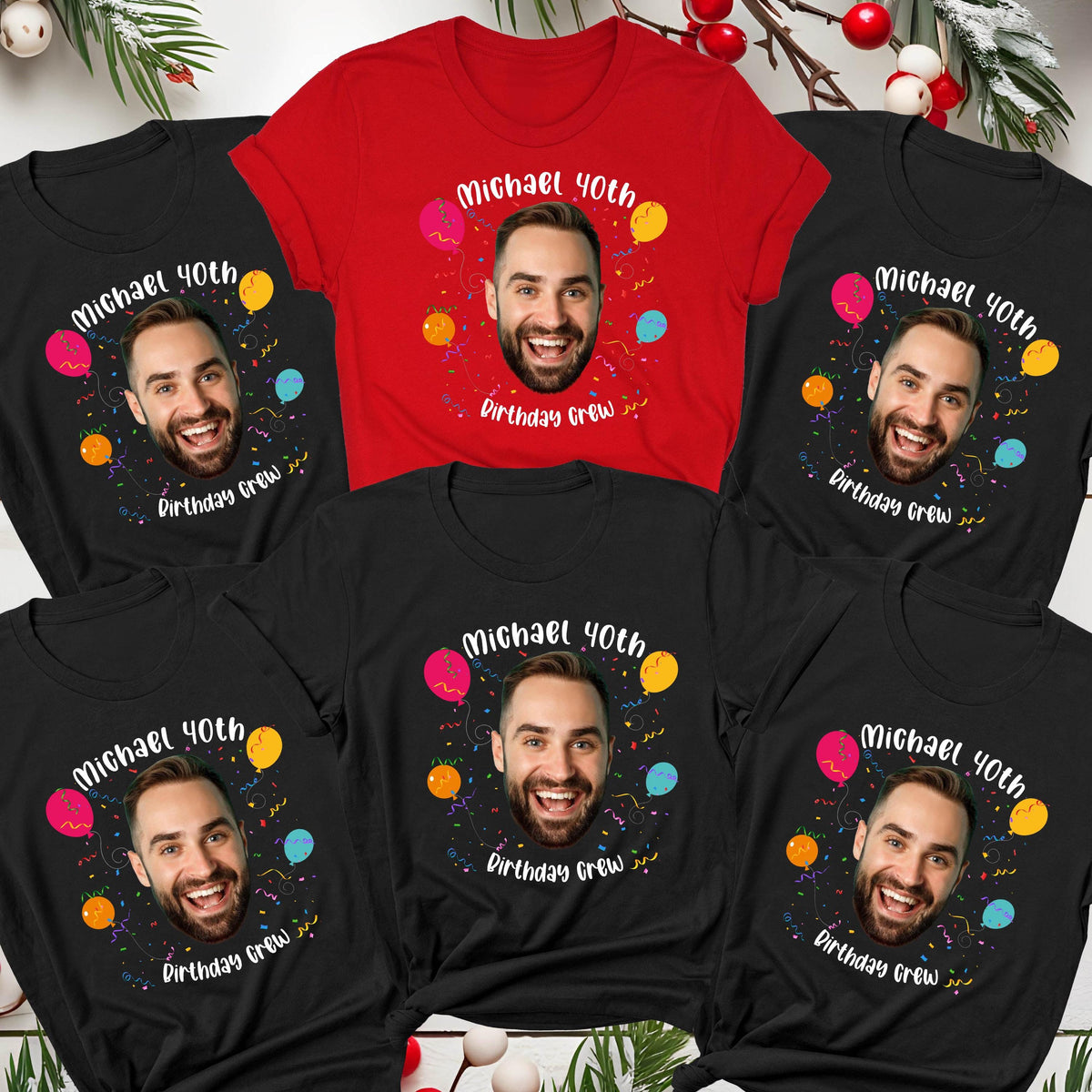 May include: A collection of five t-shirts, one red and four black, each featuring a central graphic of a man's face surrounded by colorful balloons and confetti. The text reads Michael 40th Birthday Crew in a playful white font.