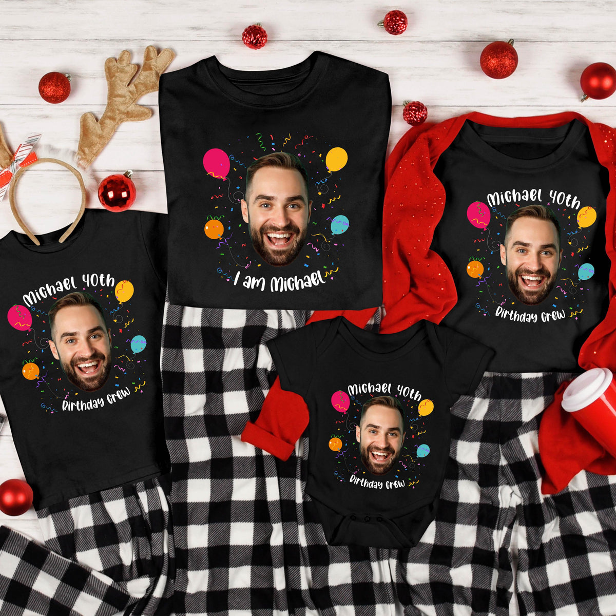 May include: A collection of black t-shirts and a baby bodysuit featuring a printed photograph of a smiling man, colorful balloons, confetti, and the text "Michael 40th" along with "I am Michael" or "Birthday Crew" in white lettering.