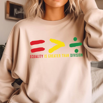 May include: A beige sweatshirt with a graphic design of an equals sign, a greater than sign, and a division sign. The text "Equality is greater than division" is printed below the graphic.