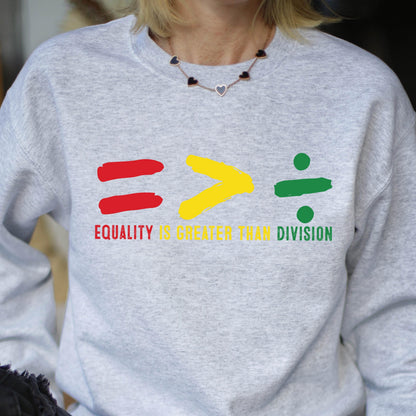 May include: A gray sweatshirt with a graphic design of an equal sign, a greater than sign, and a division sign. The text "Equality is greater than division" is printed below the graphic.