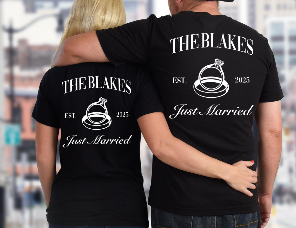 May include: A couple wearing matching black t-shirts with white text that says "The Blakes Est. 2025 Just Married" and a graphic of two interlocking rings with a diamond. 