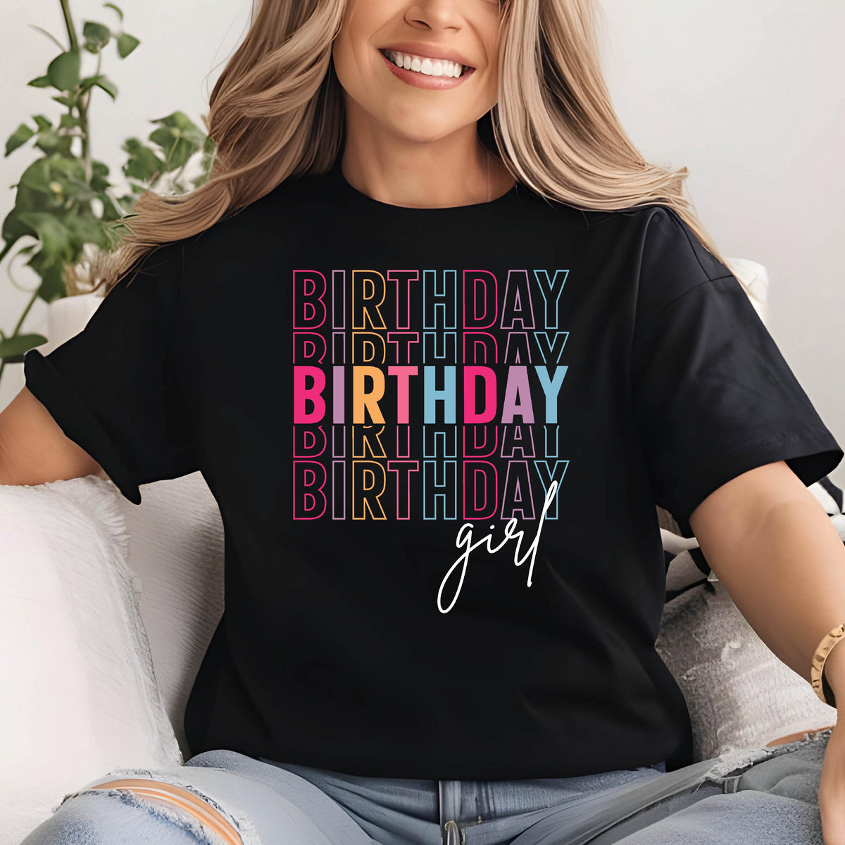 May include: Black t-shirt with the word "BIRTHDAY" stacked vertically in colorful text. The word "BIRTHDAY" is repeated multiple times in different colors, with "girl" written in cursive below. The shirt is a casual style.