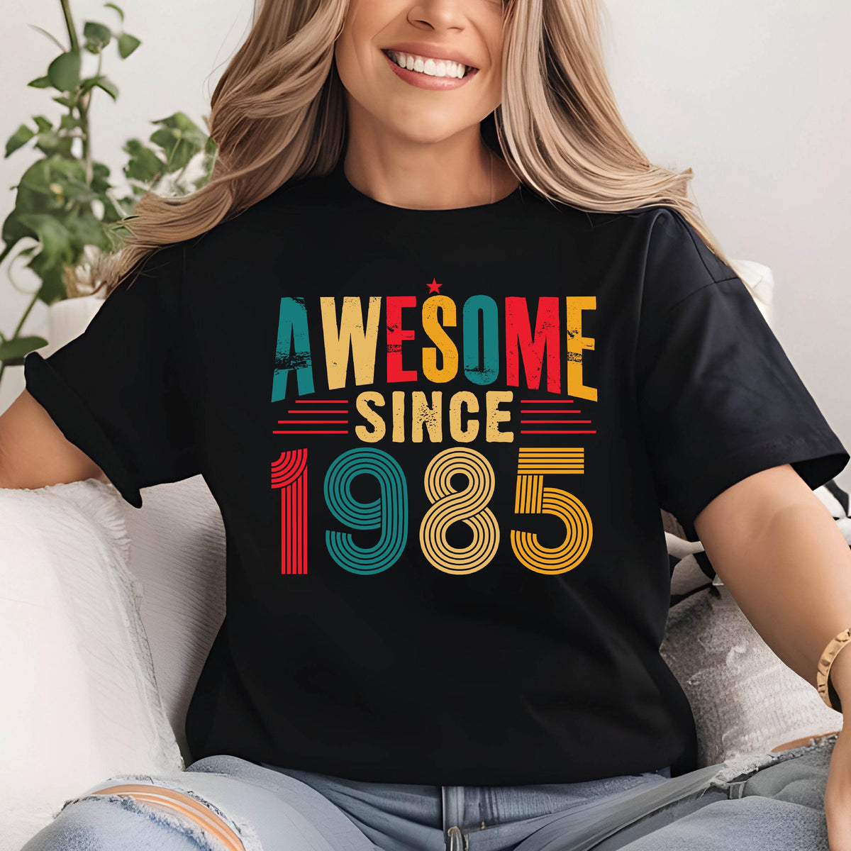 May include: Black t-shirt with a vintage-style graphic that says "Awesome Since 1985" in colorful, layered text.