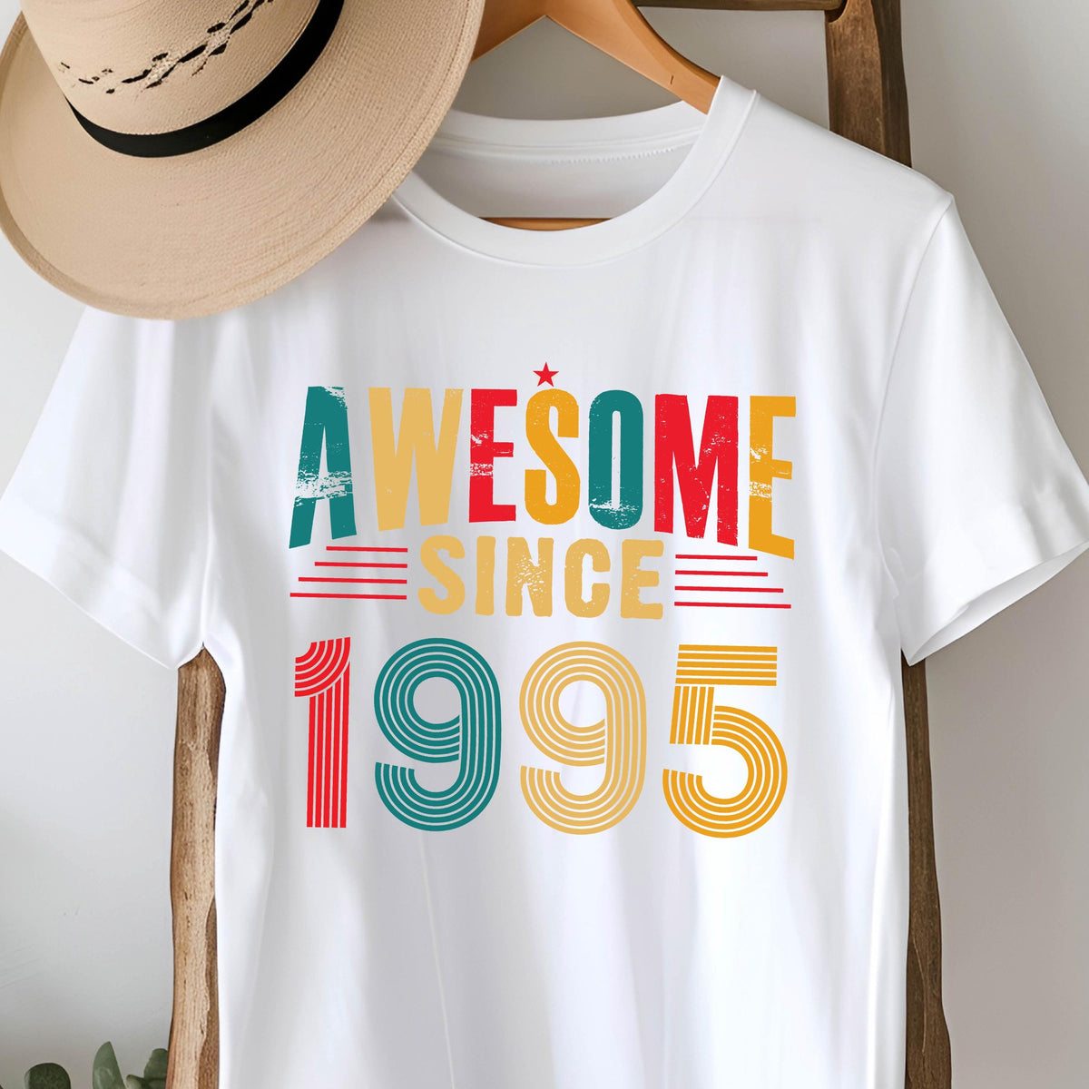 May include: White t-shirt with a vintage-style graphic that says "Awesome Since 1995" in red, yellow, green, and blue.
