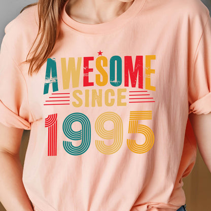 May include: A pink t-shirt with the text "Awesome Since 1995" in a retro style font with colorful stripes. 