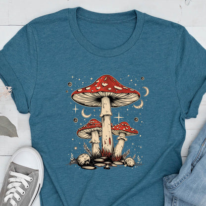May include: A blue t-shirt with a graphic of three red and white mushrooms with white stems against a dark blue background with white stars and crescent moons.