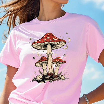 May include: Pink t-shirt with a graphic of three red and white mushrooms with white stems against a background of white stars and crescent moons.